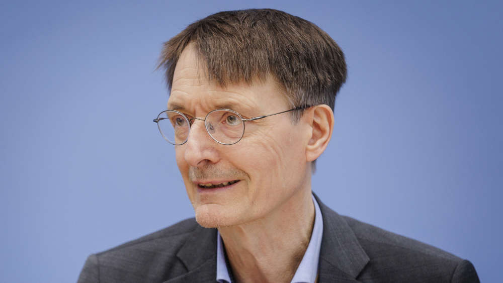 Mann mit Brille und Anzug auf einem Podium