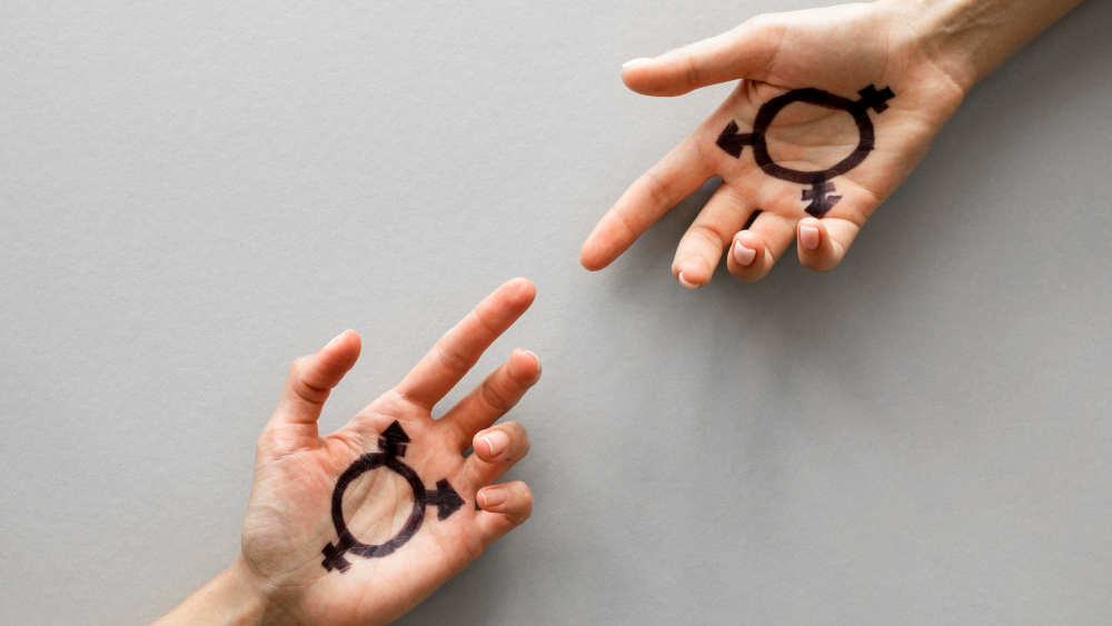 Zwei Hände mit transgender Symbolen