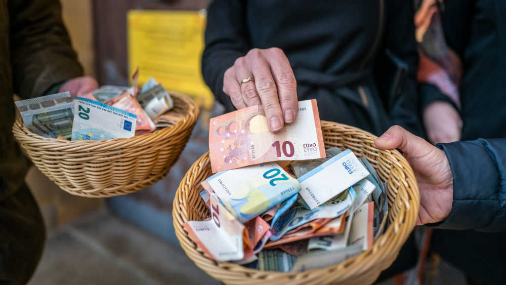Spendenaktion: zwei Körbe mit Geldscheinen